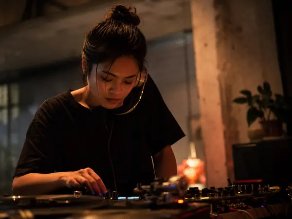 A DJ cueing a track