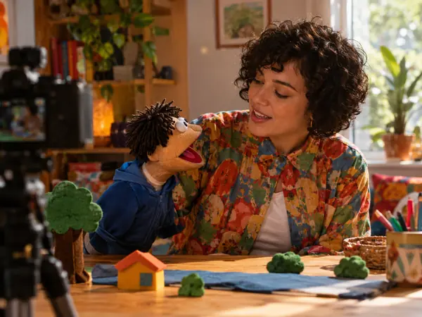 A creator filming a puppet sketch